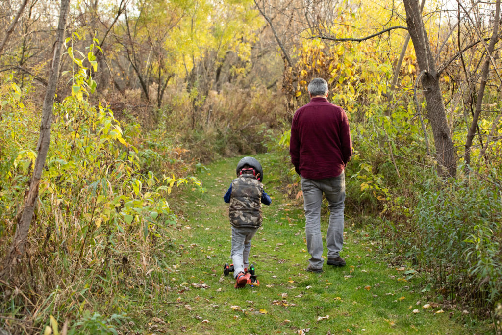  Dad and son walking during a family photo session. 