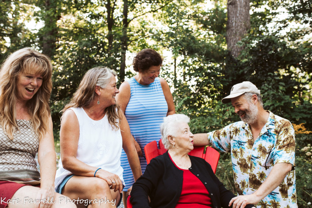 An elderly woman with her four grown children. A family photo taken in Charlotte, VT.