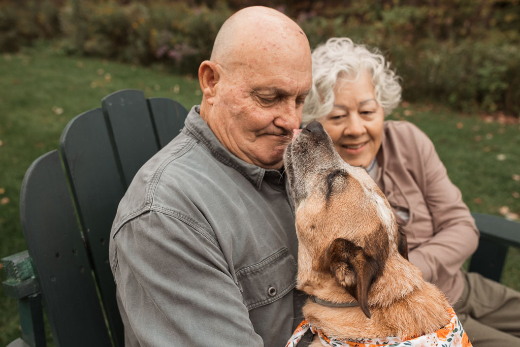 A Red Heeler gives his owner, an older gentleman, a huge kiss - Vermont Dog photography