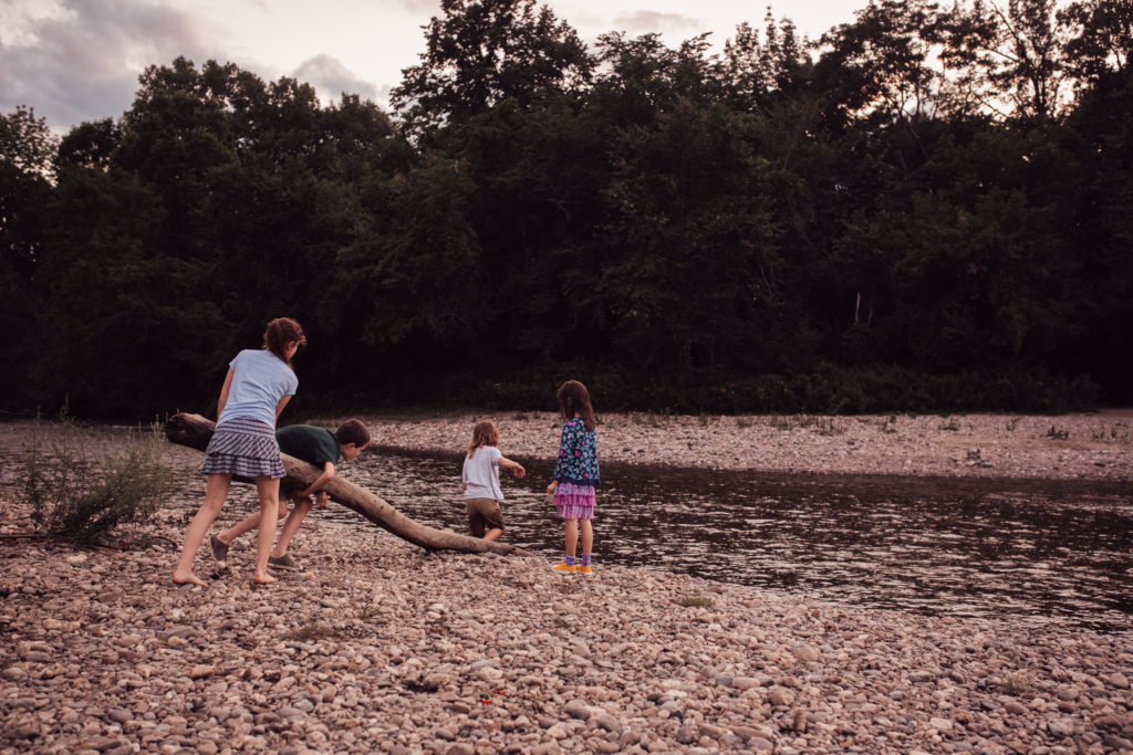 Four kids play near the Huntington River.