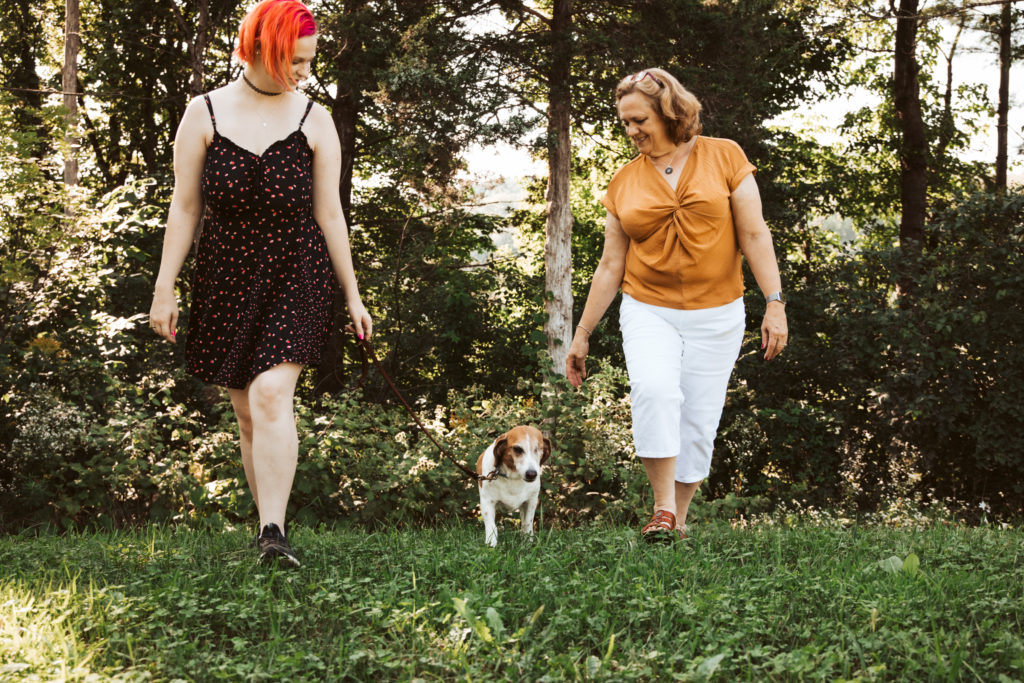 One of several professional family photos taken at a family reunion. Mom and daughter walk their beagle. 