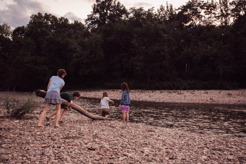 Four children play near a river in Vermont.