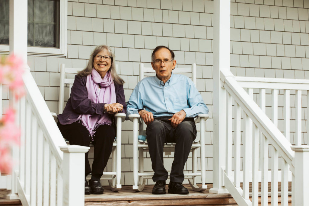 A retired Vermont couple enjoying their front porch on a spring evening.