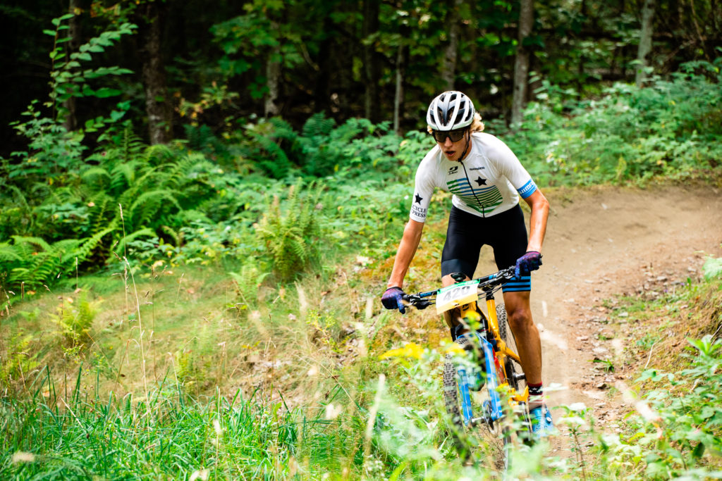 Mountain bike rider in the woods at the Vermont Youth Cycling race at Craftsbury, VT.