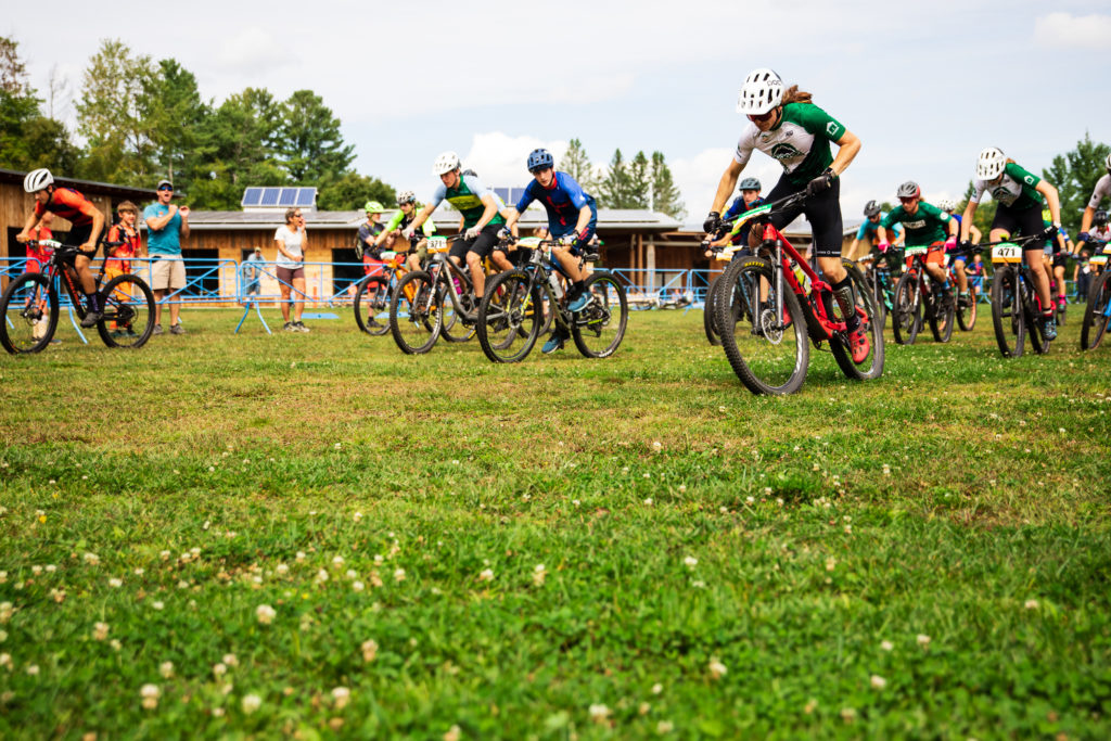 Mountain bike riders in a pack at the start of the Vermont Youth Cycling race at Craftsbury, VT.