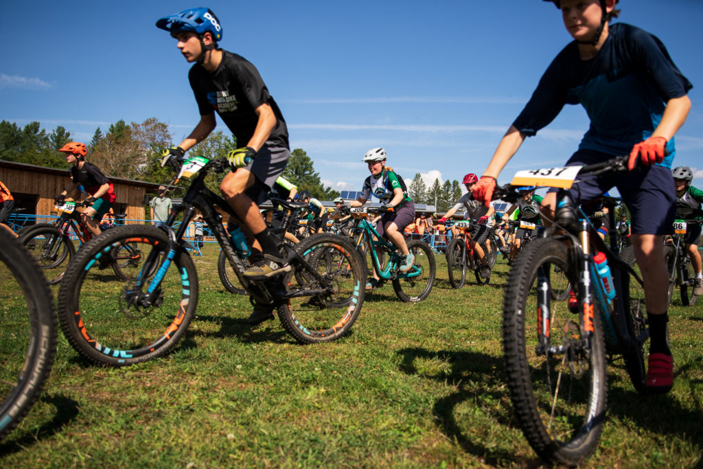 Mountain bike riders in a pack at the start of the Vermont Youth Cycling race at Craftsbury, VT.