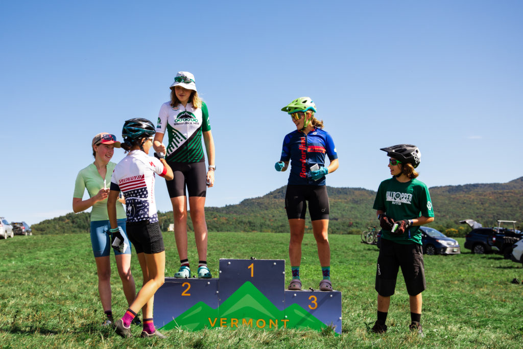  Vermont Youth Cycling Race at the Kingdom Trails. Top Cat A girls fist bumps.