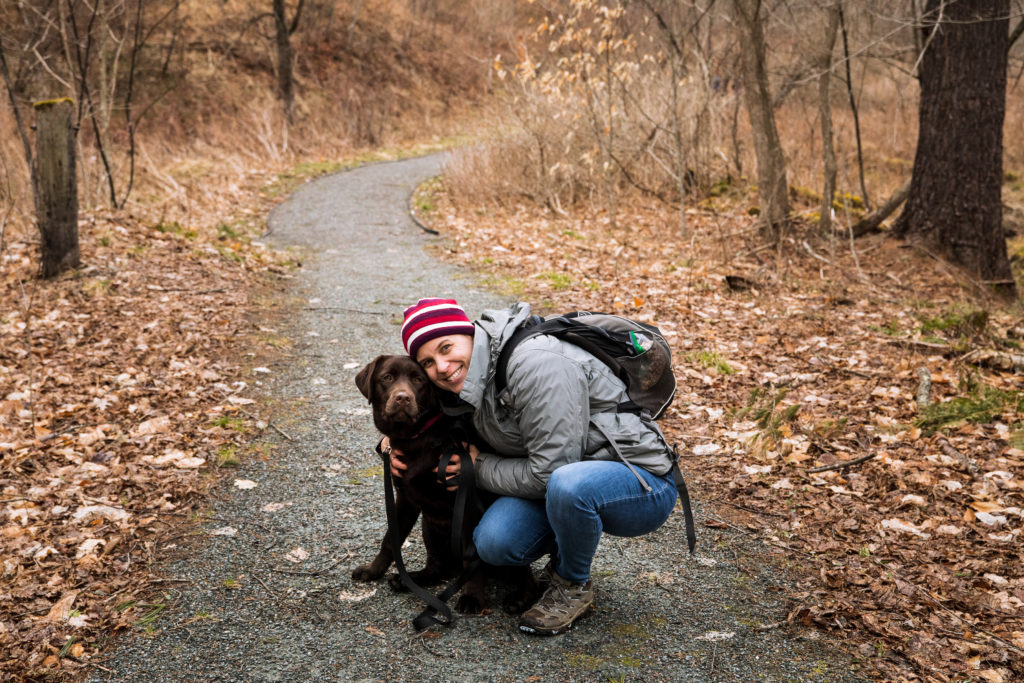 Me (Kate Farrell) with my dog (Willow) on a late winter hike.) A cloudy day photo.