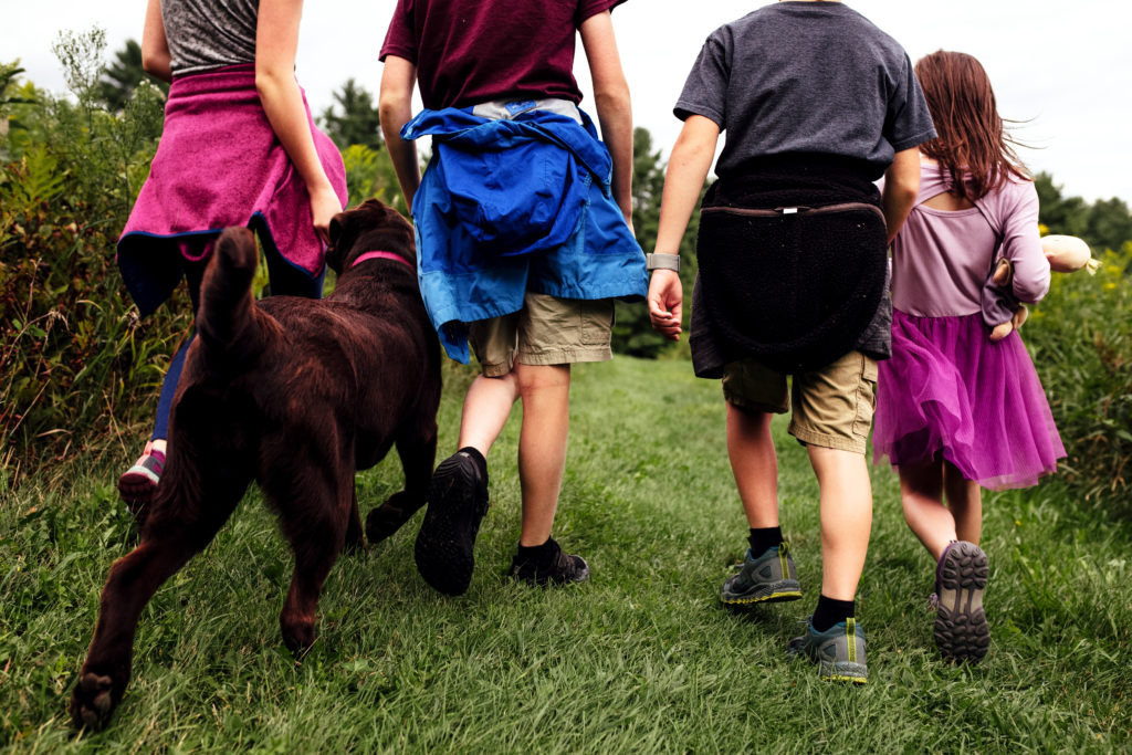 Four young people walking their dog, view from behind - Vermont Outdoor Family Photography