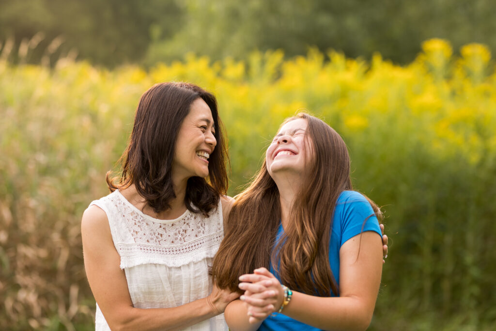 Mother and daughter laughing, a lifestyle family photography example.