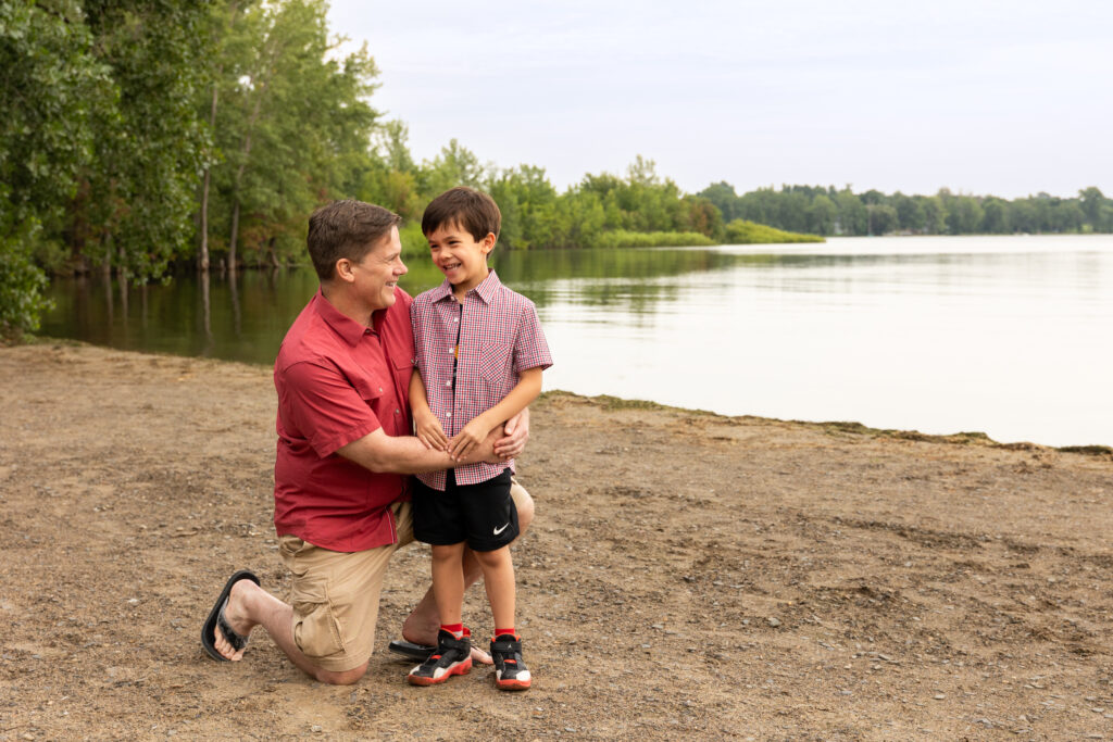 Father and son on a beach near Lake Champlain. Family Lifestyle Photography.